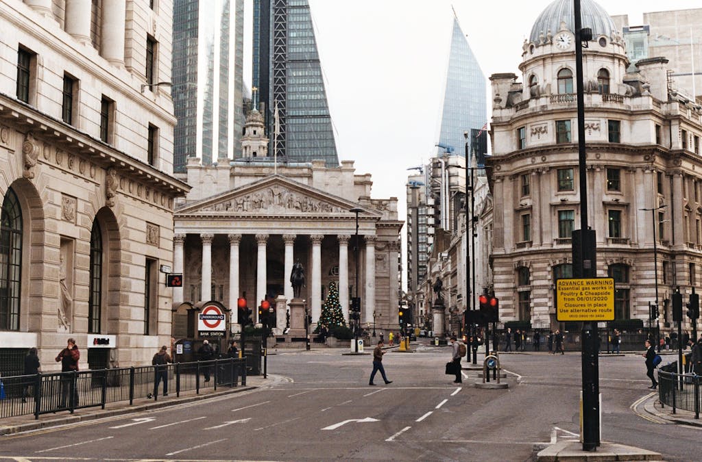 A vibrant street in London with historical architecture and bustling pedestrians.